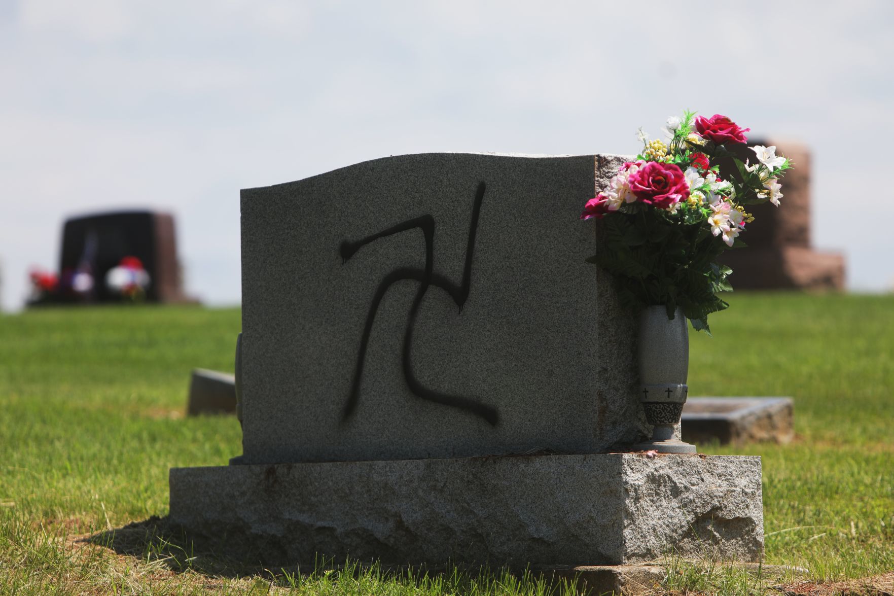 Vandal spray-paints swastikas 150 to 200 headstones and markers